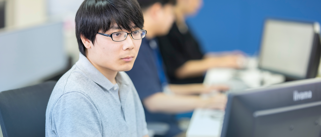 オフィスでパソコン作業に集中する社員の様子